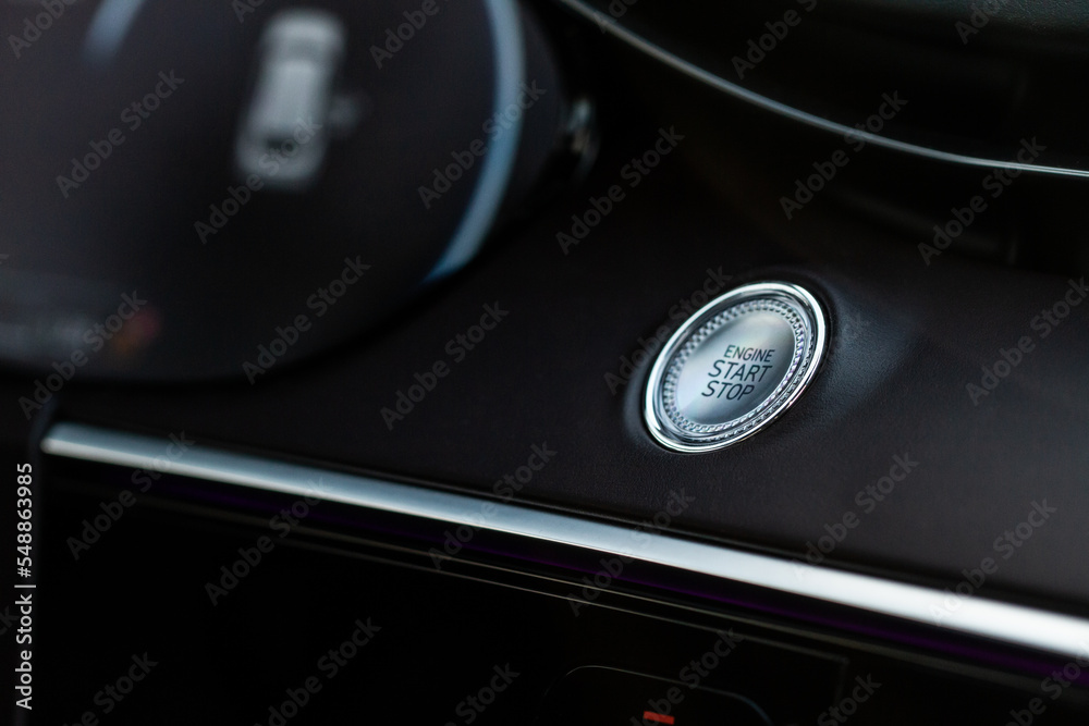 Engine start button. Close up engine car start stop button. Modern car interior details. Engine start button. Close up engine car start stop button. Modern car interior details.