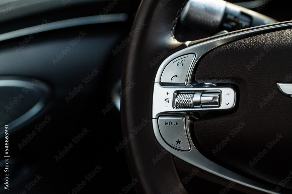 Call buttons on car steering wheel. Audio control buttons on the steering wheel of a modern car.