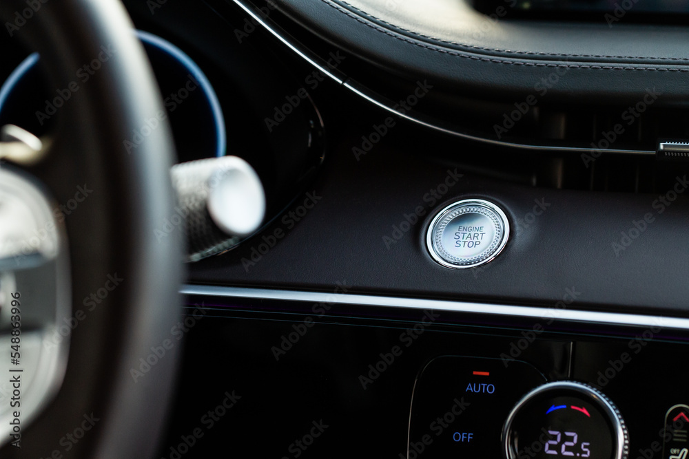 Engine start button. Close up engine car start stop button. Modern car interior details.