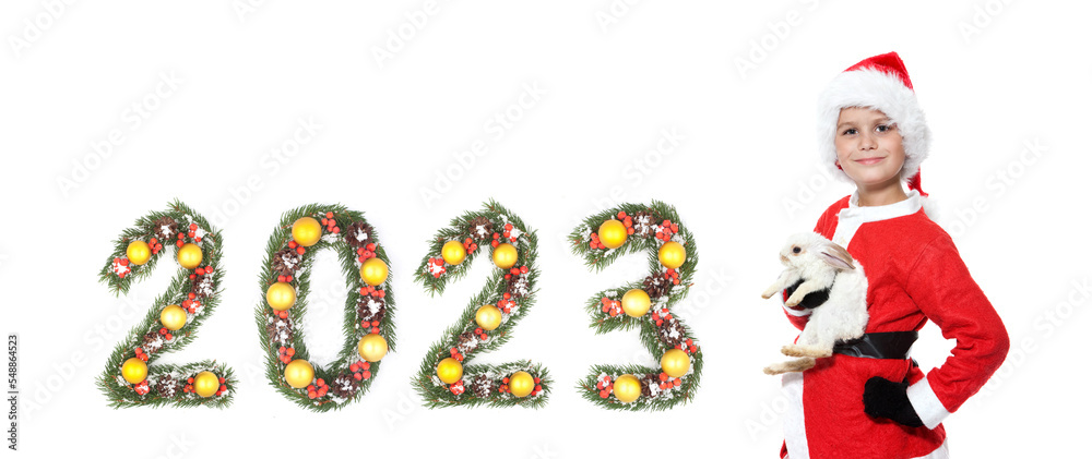Boy holding a christmas rabbit and 2023 number Boy holding a christmas rabbit and 2023 number