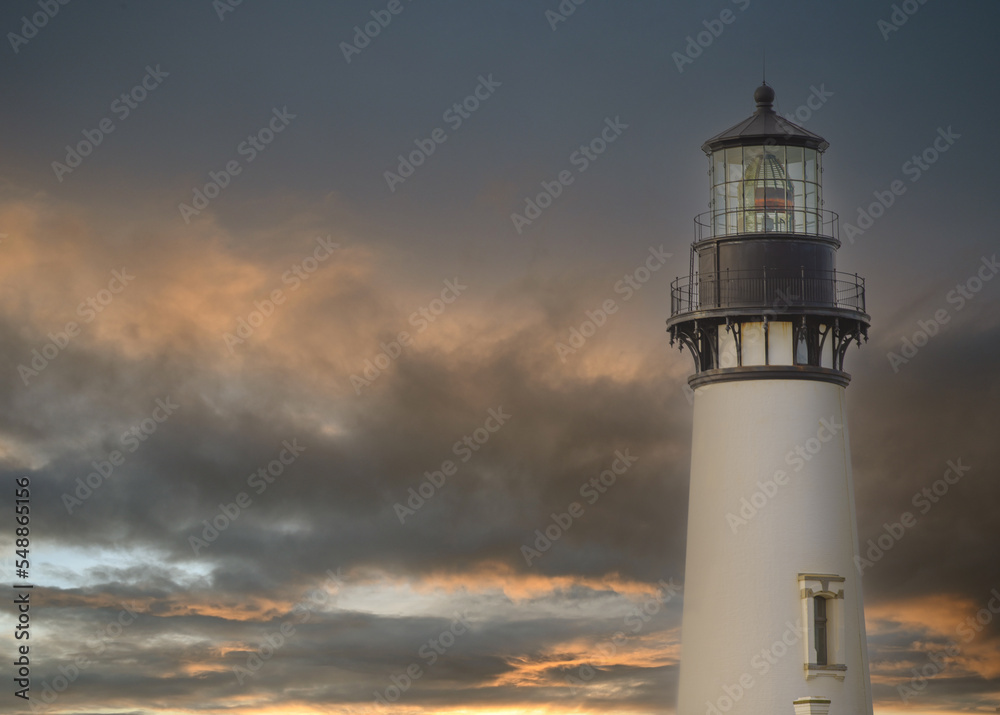 Beautiful white lighthouse against the sky with thunderclouds. Twilight. Beautiful landscape. Maritime navigation, architecture, construction, travel, tourism, weather, ecology.