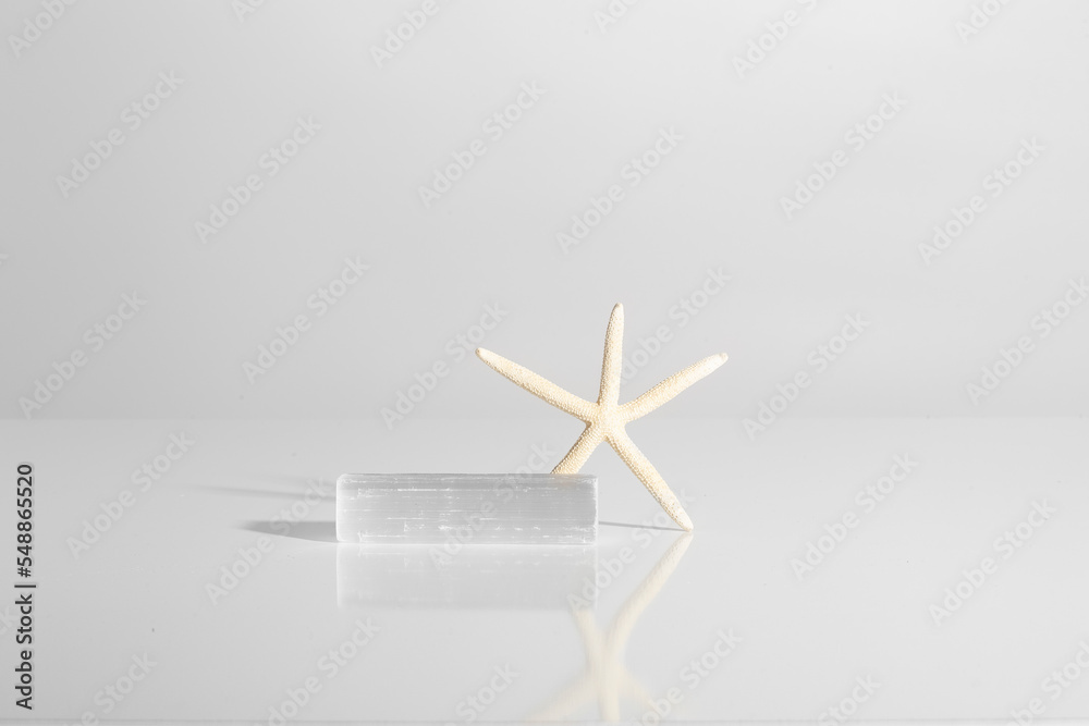 crumpled piece of paper and starfish on hard light white background crumpled piece of paper and starfish on hard light white background