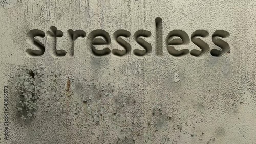 animation of stressless living word carved in a grey wall photo