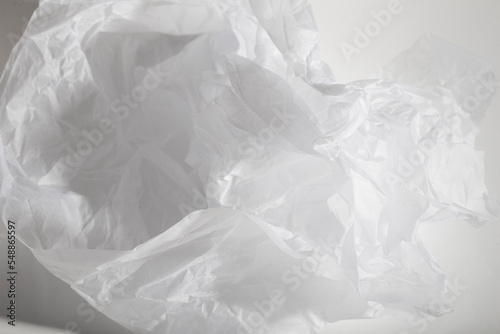 crumpled piece of paper against a harsh light white background