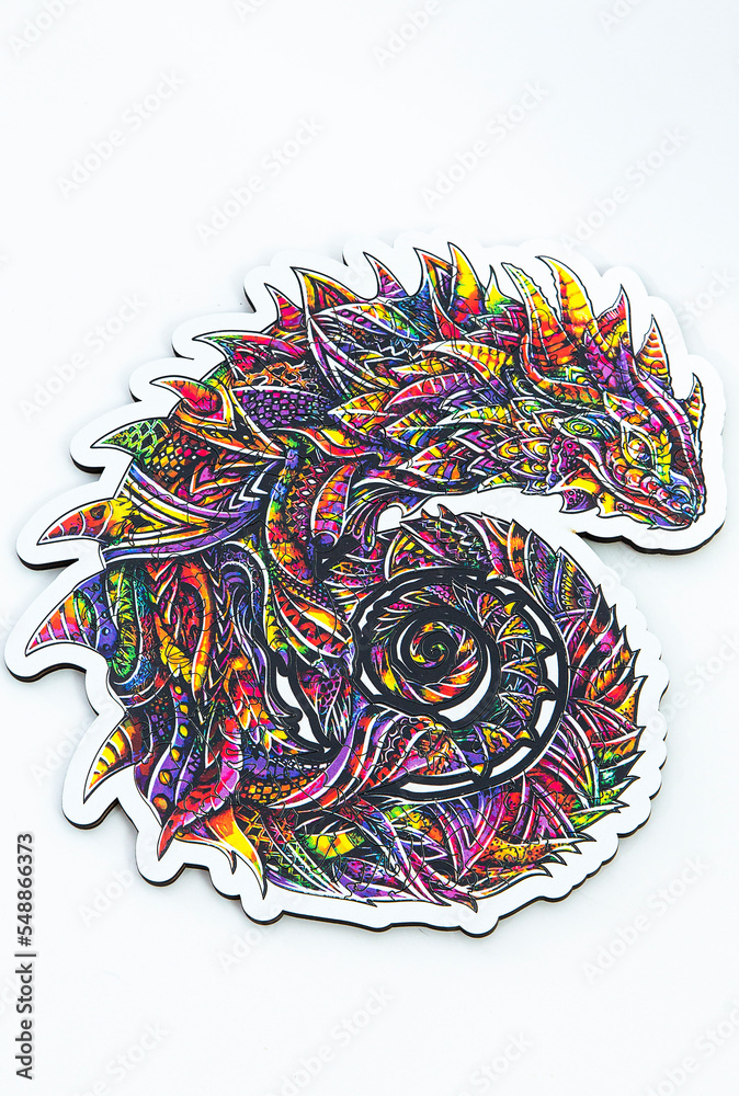 Fototapeta premium wooden puzzle figurine in the form of an iguana. Logic game for adults and children. top view