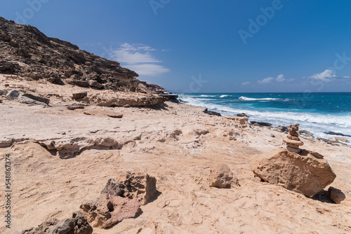 Rocky desert coastline hiking trail with turquoise waters, Canary Islands, Spain