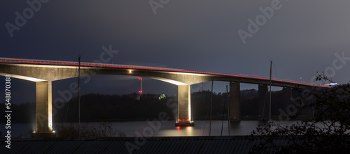 Obraz na płótnie Landscape view of traffic on the illuminated highway Alssundbroen, high car bridge over Alssund north of Sønderborg, Denmark. Long-exposure shot at night. w salonie