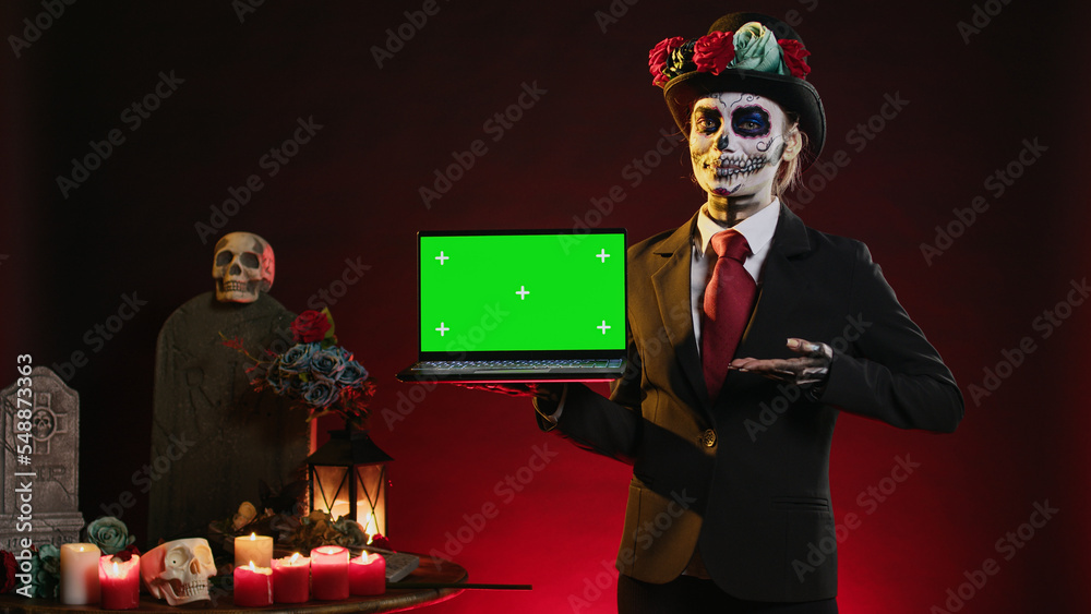 Scary female model holding laptop with greenscreen display, showing ...