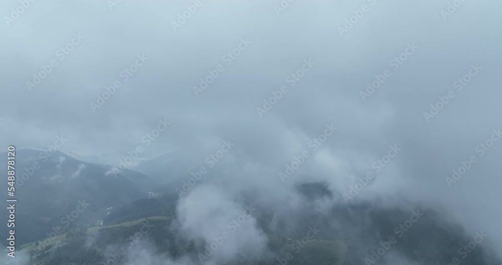 Rainy weather in mountains. Misty fog blowing over pine tree forest. Aerial footage of spruce forest trees on the mountain hills at misty day. Morning fog at beautiful forest. Rainy weather in mountains. Misty fog blowing over pine tree forest. Aerial footage of spruce forest trees on the mountain hills at misty day. Morning fog at beautiful forest.