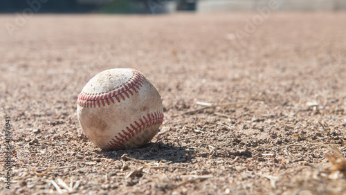 Close-up of a Baseball on the ground in a ballpark, USA photo
