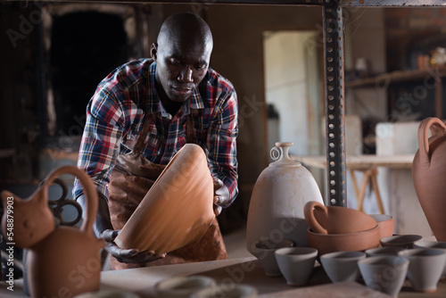 Print op canvas Young African American male hobbyist engaged in stoneware production in pottery