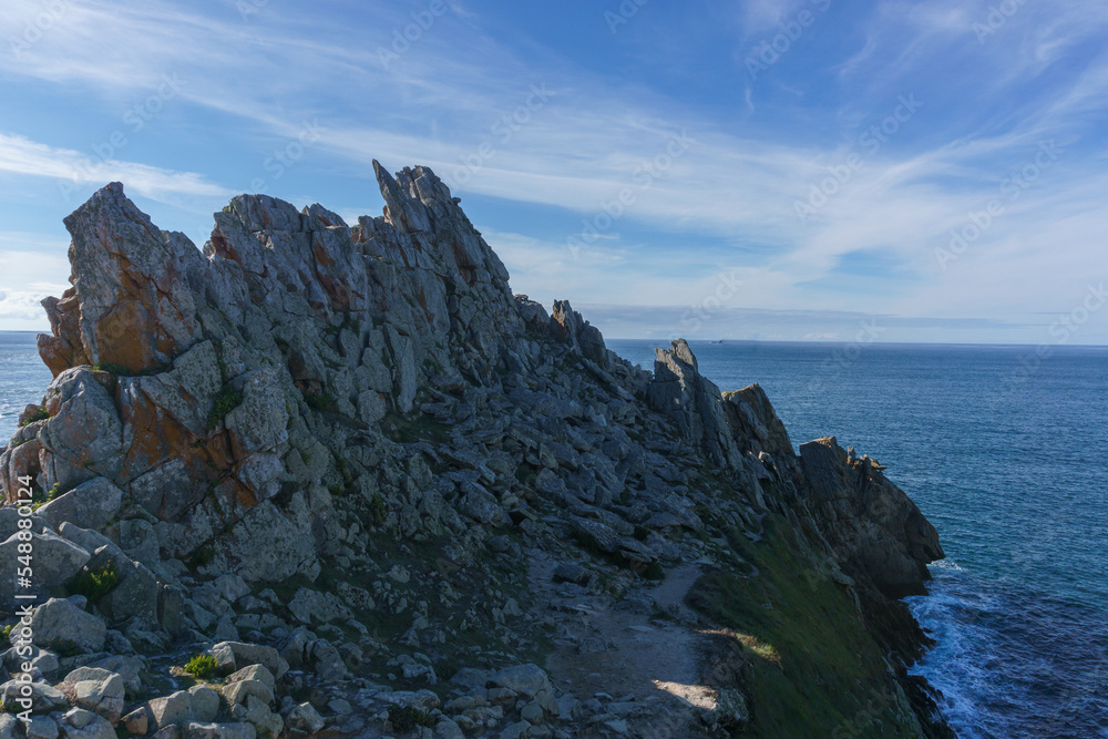 Rocks at the coastline of Pointe du Raz with view at the atlantic ocean, Plogoff, Finistere, Brittany, France