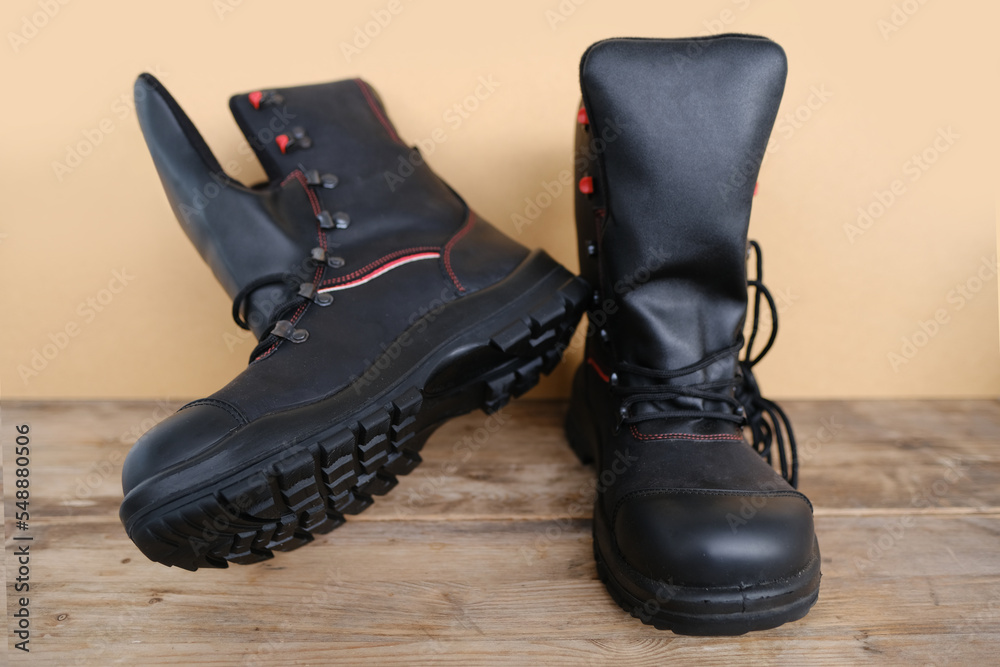 close-up of pair of new black Safety Shoes, work boots made of leather with reinforced cape on old wooden boards, concept of special protective workwear, professional shoes, work safety close-up of pair of new black Safety Shoes, work boots made of leather with reinforced cape on old wooden boards, concept of special protective workwear, professional shoes, work safety