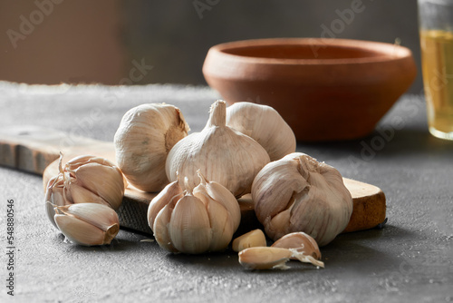 Whole garlic with peel, organic product, garlic cloves on a table. healthy gastronomy concept