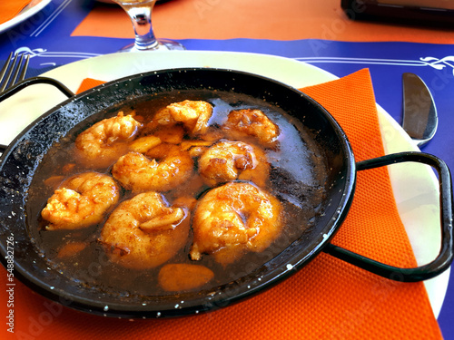 Sizzling dish of a popular Spanish Delicacy called Prawns PilPil in a restaurant on the seafront in Fuengirola in Spain make a tasty lunch