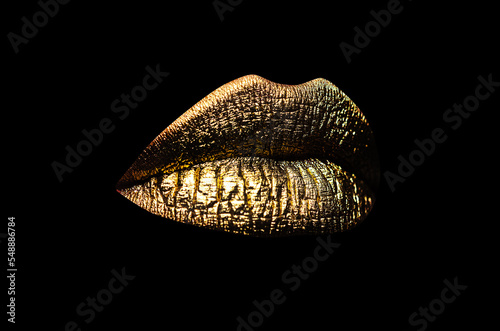 Luxury glamour art mouth. Golden lips isolated on black background. Clipping path gild lips.
