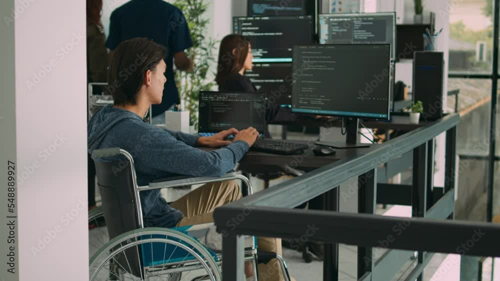 Focused software developer in wheelchair writing server code in agency data room, using security system. Engineer with physical disability programming user interface artificial intelligence office. Focused software developer in wheelchair writing server code in agency data room, using security system. Engineer with physical disability programming user interface artificial intelligence office.