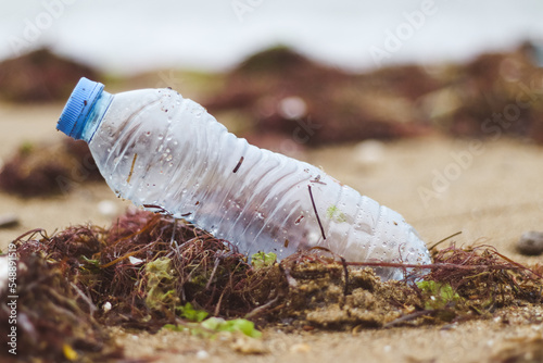 plastic pet bottle standing on the beach. Marine pollution concept