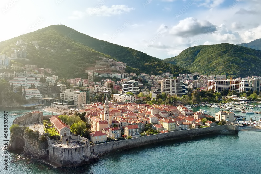 Panoramic sunset aerial drone view of the ancient city of Budva, Montenegro. Old medieval town.
