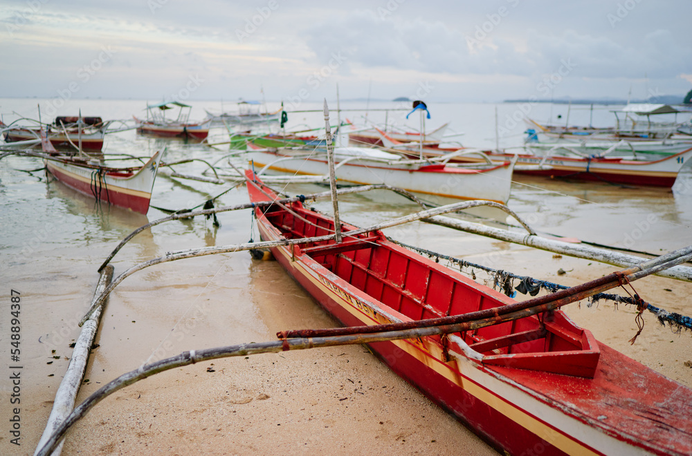 Beach with traditional fishing boat, Philippines.