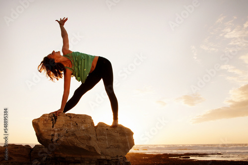 Joyful woman playing yoga and with the wind in her hair. 