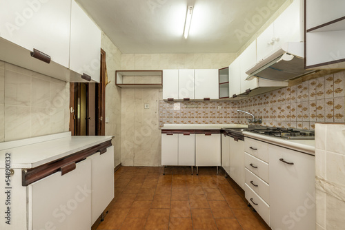 old kitchen with white wood-edged cabinets  white wood countertops and vintage tiles