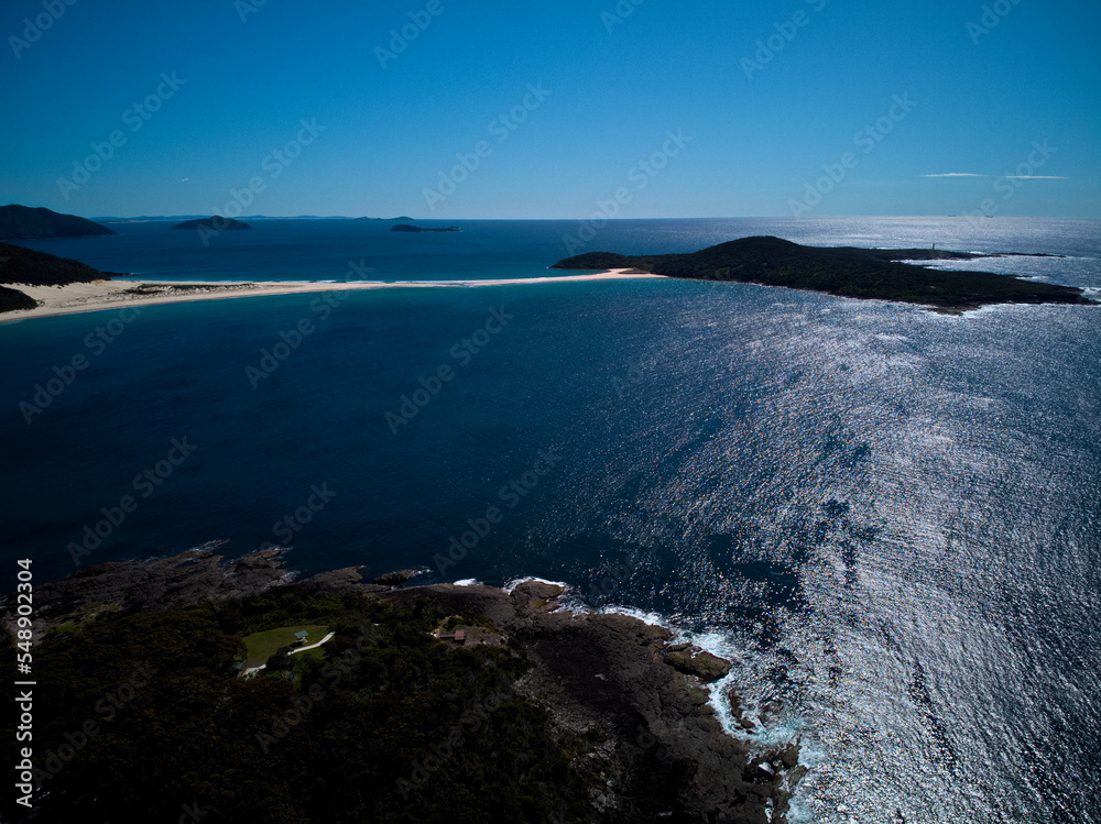 Drone photo of Fingal Bay and the spit leading to Shark Island on a bright sunny day