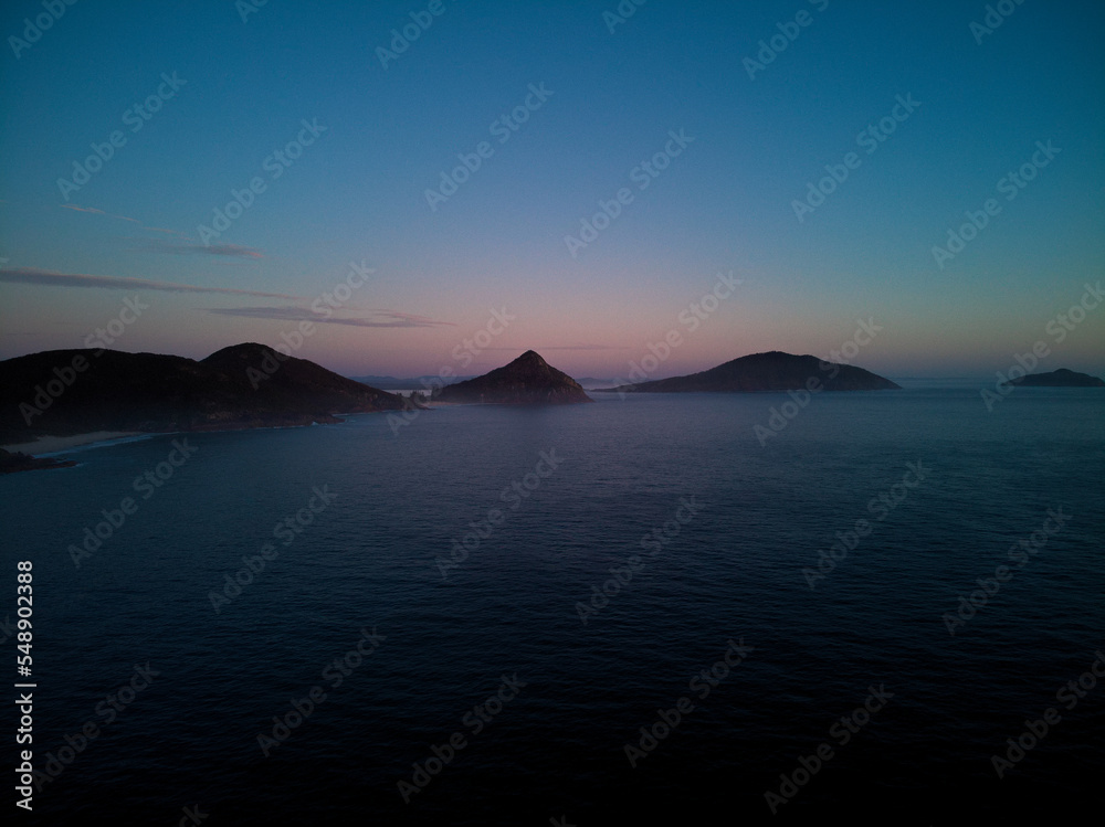 Drone photo from Fingal Beach to Tomaree Mountain in Port Stephens, just prior to sunrise.