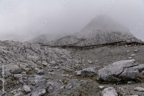 Lijiang Jade dragon snow mountain of Yunnan, China in fog, view from the footsteps
