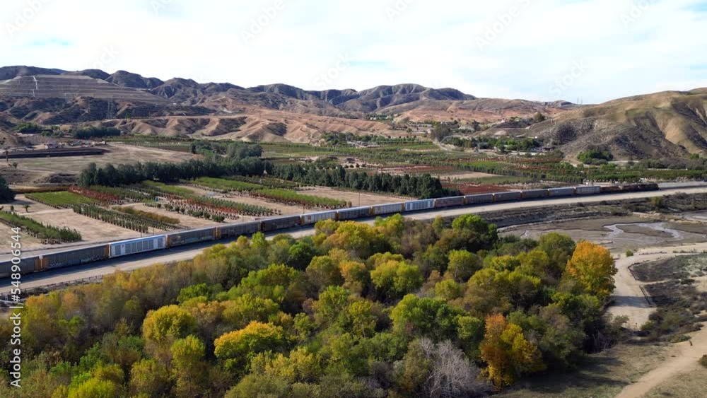 A UAV Drone View of a Cargo Diesel Electric Train Passing through Live Oak Canyon and a Forested Area Near Redlands, California A UAV Drone View of a Cargo Diesel Electric Train Passing through Live Oak Canyon and a Forested Area Near Redlands, California