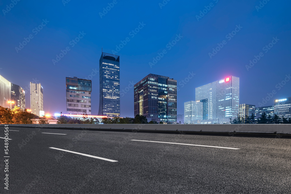 Background of asphalt pavement and urban architectural landscape skyline