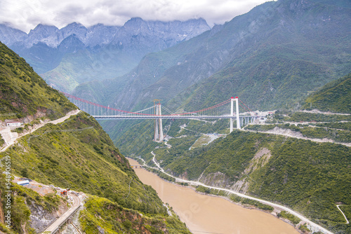 A bridge across Tiger Leaping Gorge and Jinsha River. Located 60 kilometres north of Lijiang, Yunnan, China. photo