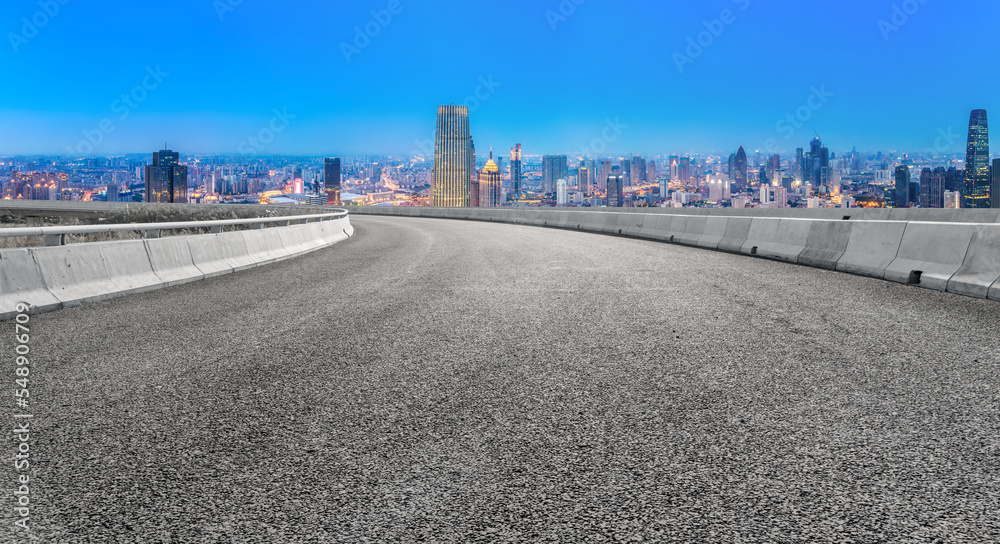 Background of asphalt pavement and urban architectural landscape skyline