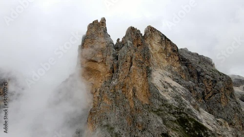 Aerial views of italian Dolomites peaks in a foggy and cloudy day photo
