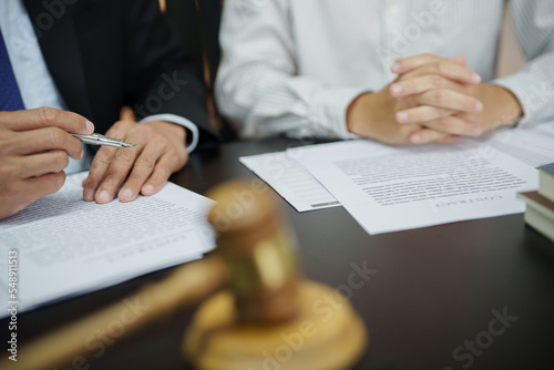 Lawyer with lawsuit meeting with client discussing with contract agreement at courtroom..