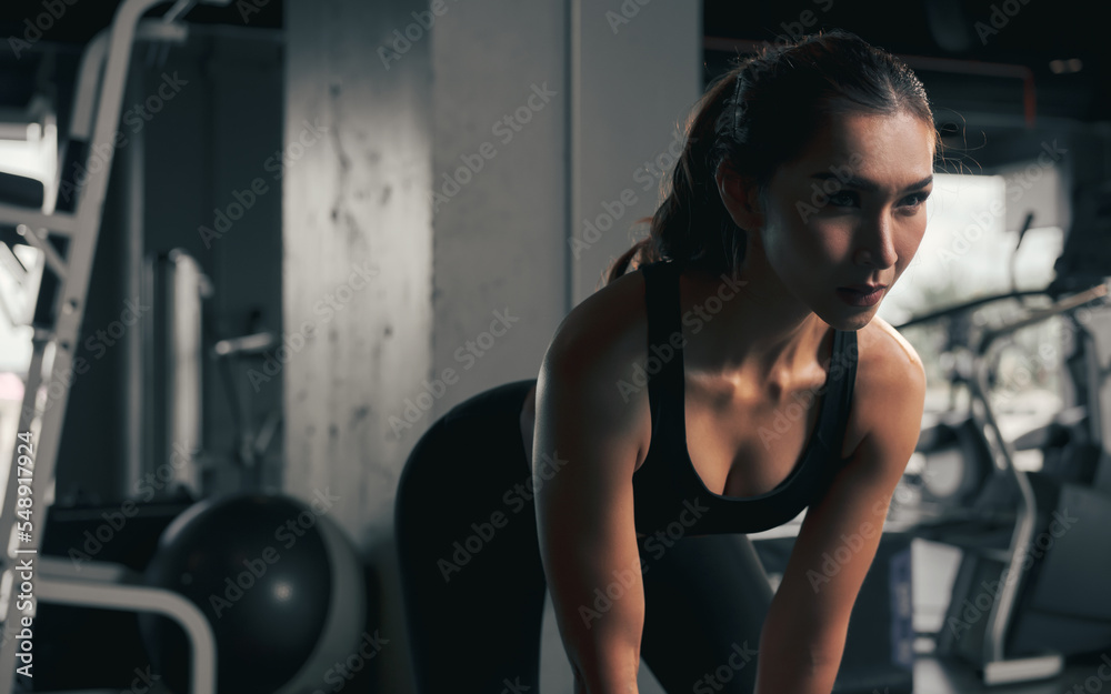 Close-up young woman lifts single kettlebell in the gym. Close-up young woman lifts single kettlebell in the gym.
