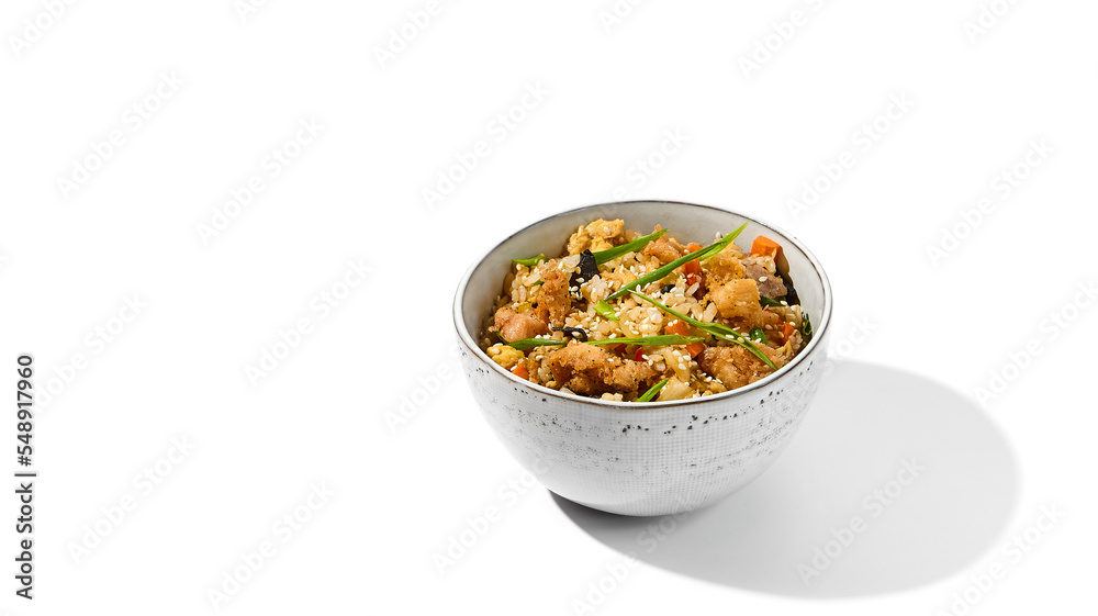 Fried rice with egg, chicken and vegetables isolated on white background. Traditional chinese food - fried rice with chicken meat in ceramic bowl Nasi goreng with fried rice, chicken and egg Fried rice with egg, chicken and vegetables isolated on white background. Traditional chinese food - fried rice with chicken meat in ceramic bowl Nasi goreng with fried rice, chicken and egg