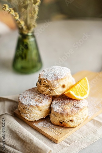 Closeup of baked British scones on kitchen wooden board