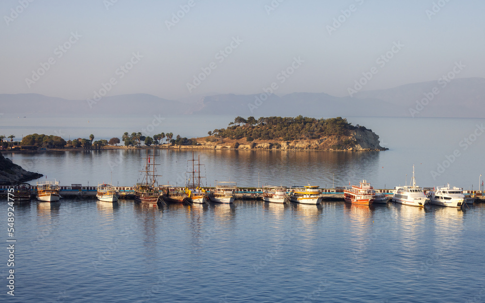 Boats at Marina on the Coast in a Touristic Town by the Aegean Sea. Kusadasi, Turkey. Sunny Morning Sunrise.