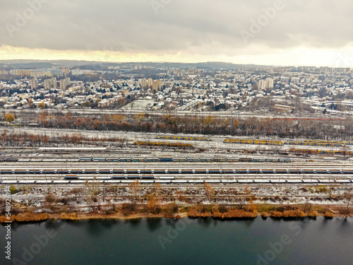 Obraz na płótnie Freight trains up close. Aerial view of colorful freight trains at a railroad station. Carriages with goods on the railroad. Heavy industry. Industrial conceptual scene with trains. Aerial view w salonie