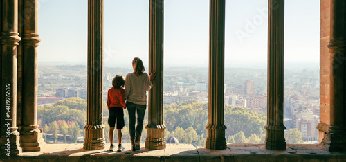 Cuadro en lienzo Mother and son tourist looking at panoramic view ( Lerida,  cloister in Spain)