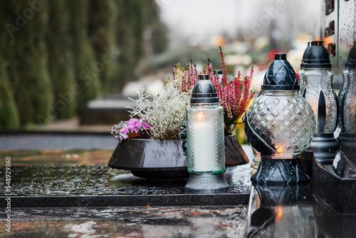 Photos All Saints' Day and burning candles and flowers on the graves