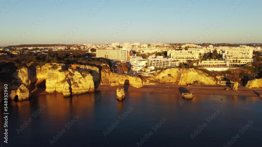 Aerial view, 4k drone shots, about Praia Dona Ana at sunrise in autumn, Lagos, in the Algarve, Portugal. Luxury and beautiful hotel on the beach. Aerial view, 4k drone shots, about Praia Dona Ana at sunrise in autumn, Lagos, in the Algarve, Portugal. Luxury and beautiful hotel on the beach.