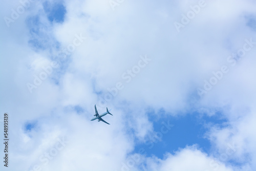 Background with an airplane in a cloudy sky