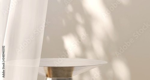 Modern and luxury gold colored round shiny pedestal podium steel in dappled sunlight from window with blowing white sheer curtain in white cream wall background for product display photo