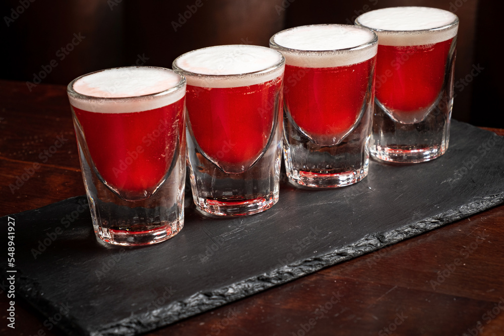 shots with vodka on wooden background shots with vodka on wooden background