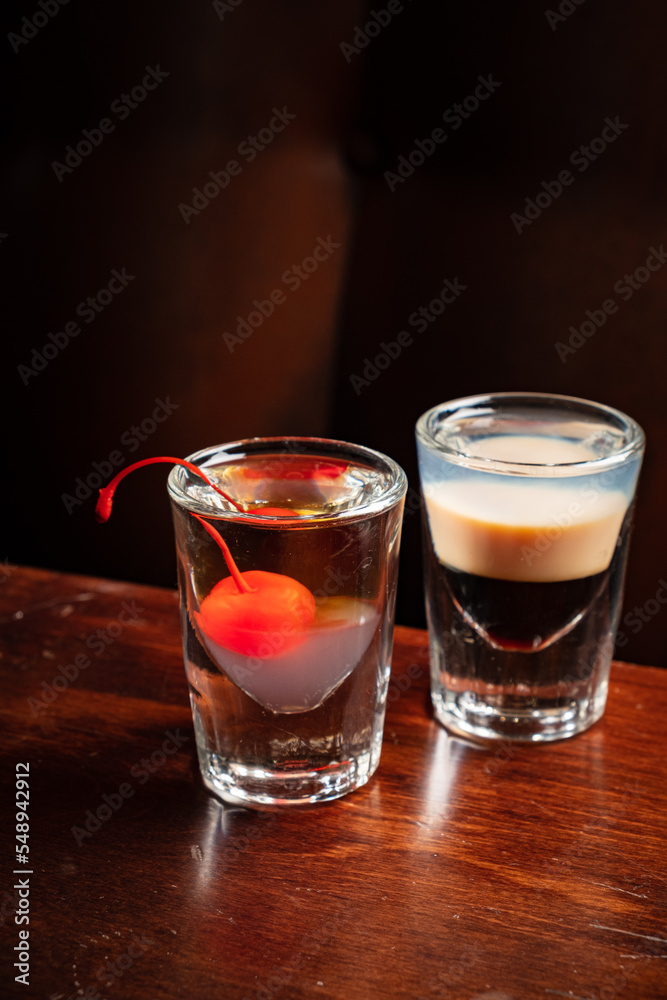 shots with vodka on wooden background shots with vodka on wooden background