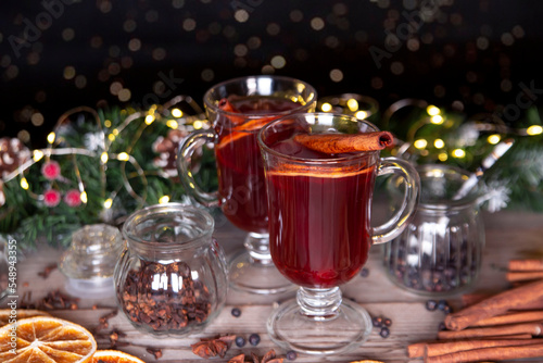 Christmas mood, holiday atmosphere. Mulled wine in glassware on a wooden table.