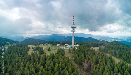 Snezhanka tower in valley of Rhodope mountains and forests against clouds. Panorama, top view