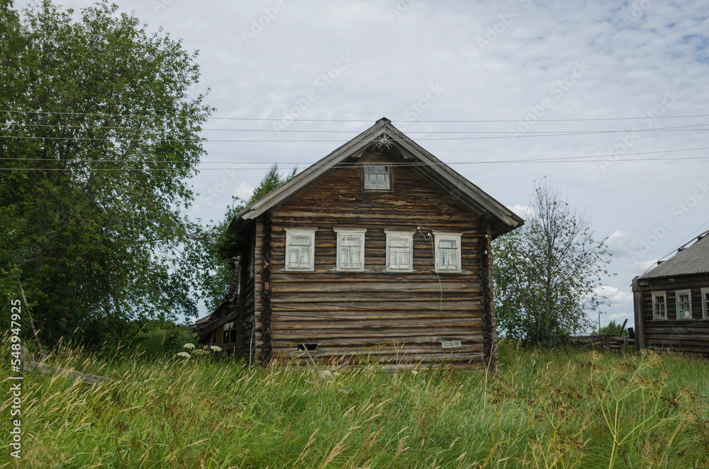 Abandoned wooden houses in the Russian village. grassy street Abandoned wooden houses in the Russian village. grassy street